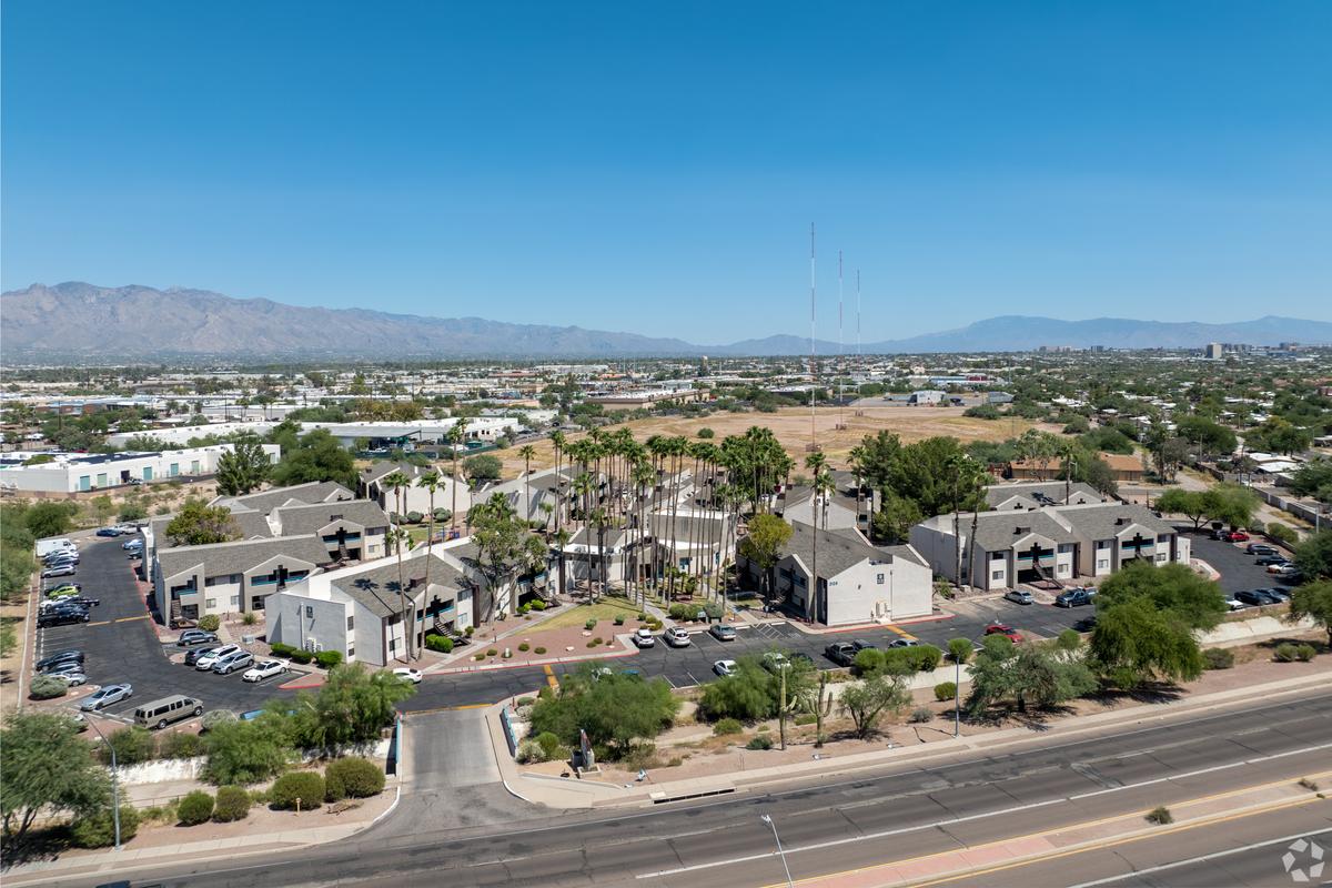 Aerial view over the property and surrounding neighborhood toward the mountains