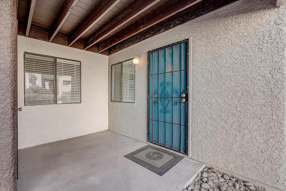 Covered patio and blue security door at the entrance of the furnished model apartment (unit 9105)